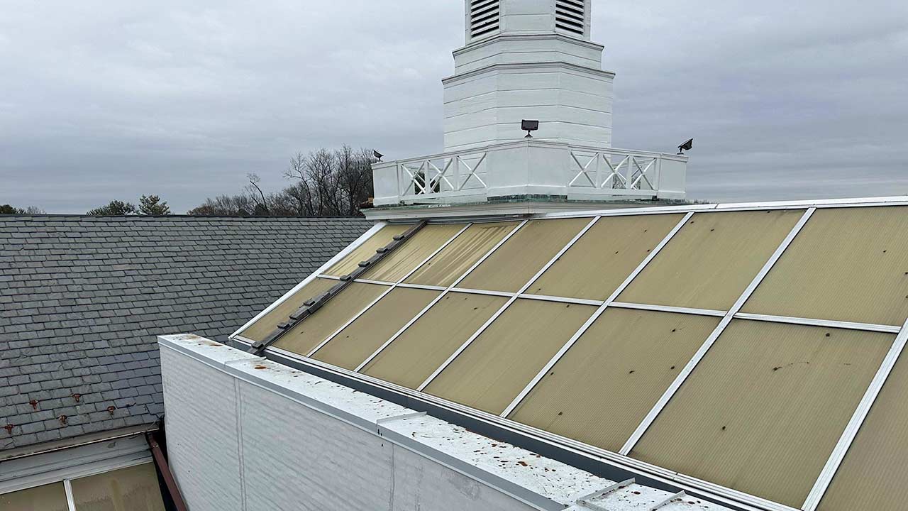 Yellowed and hail damaged skylight panels.