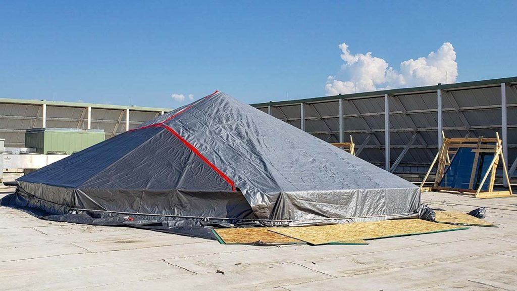 The skylight is covered with tarps overnight.