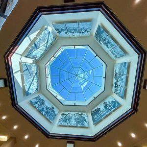 A clear sky view and the eight murals mounted in the skylight shaft.