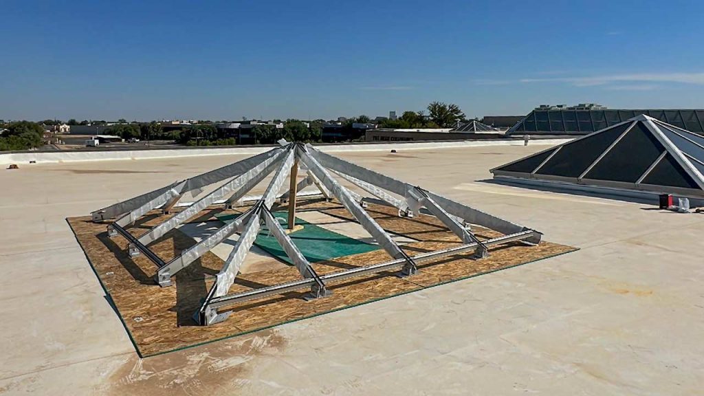 A nearly completed frame sits ne4xt to an existing skylight.