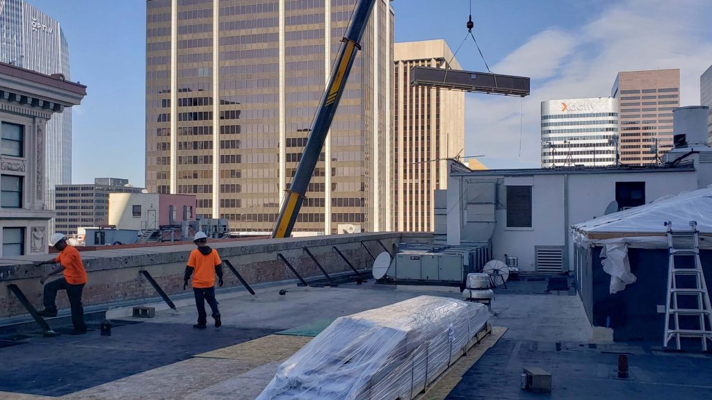 The second crate is being lowered to the roof.