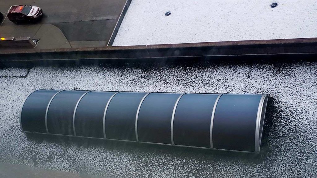 A barrel vault skylight on a hotel roof see from above.