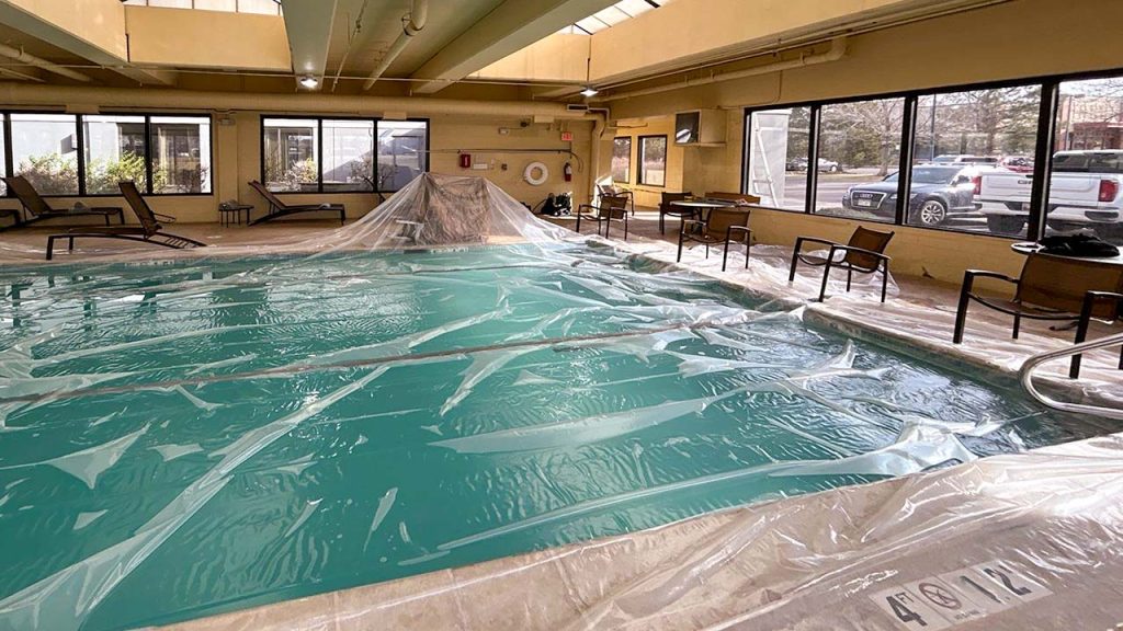 Plastic sheeying covers the pool to catch debris.