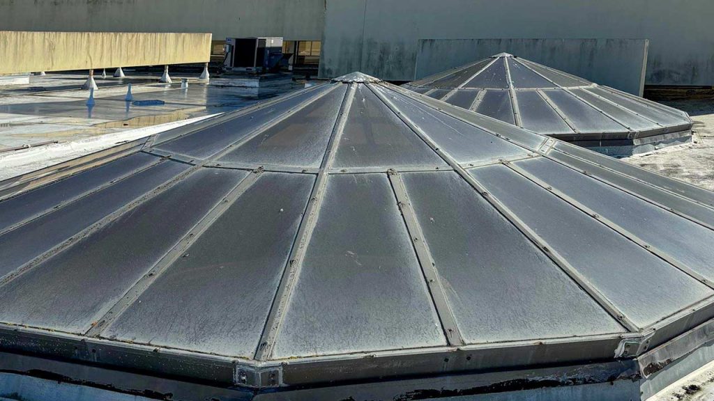 A broad vire of two weathered skylights on the roof