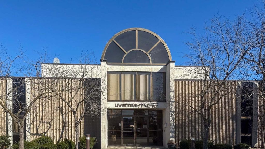 A streetview of the WETM-TV building with the barrel vault skylight sitting above the entrance.