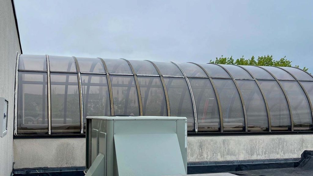 A view from the roof of the completed barrel vault skylight panel replacement.