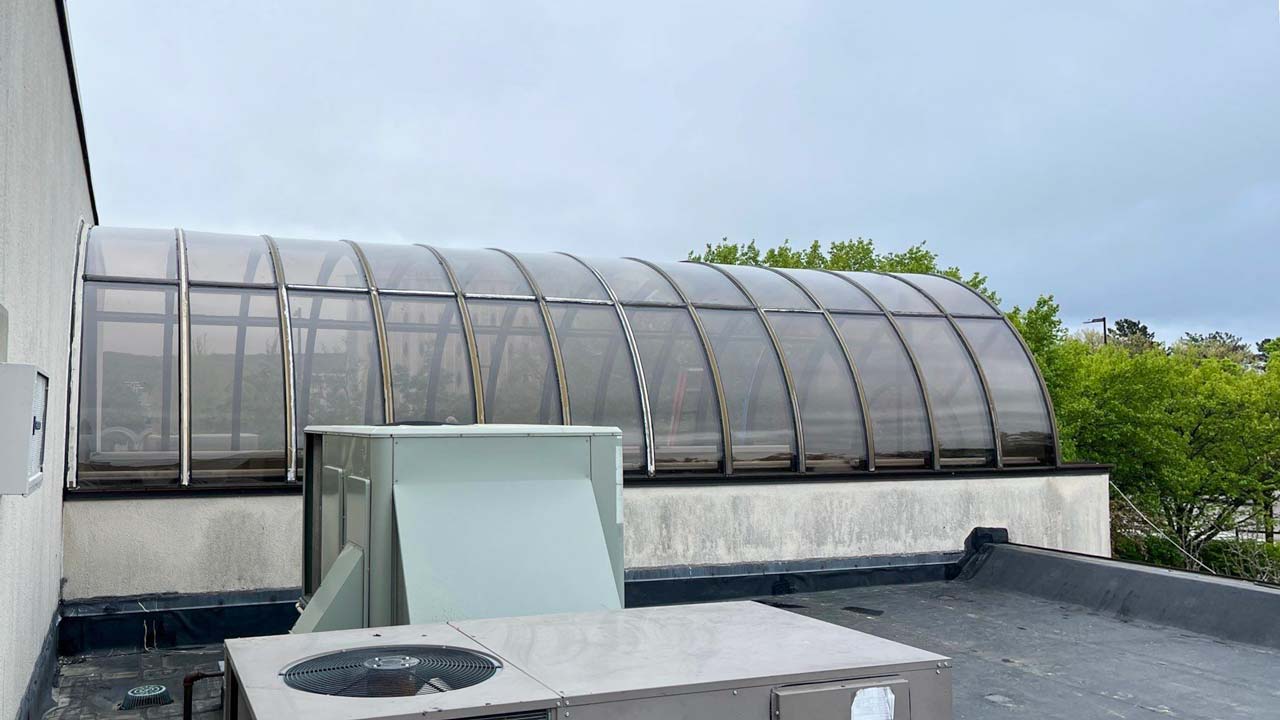 A roof with a barrel vault skylight, highlighting a blend of functionality and aesthetics.