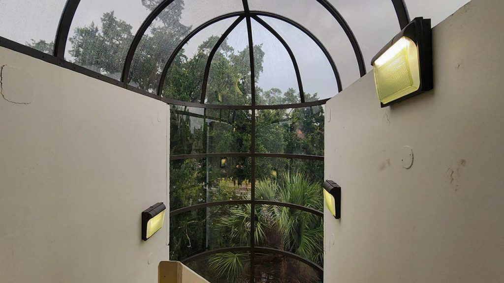 A stairwell featuring a polycarbonate ceiling and wall panels.