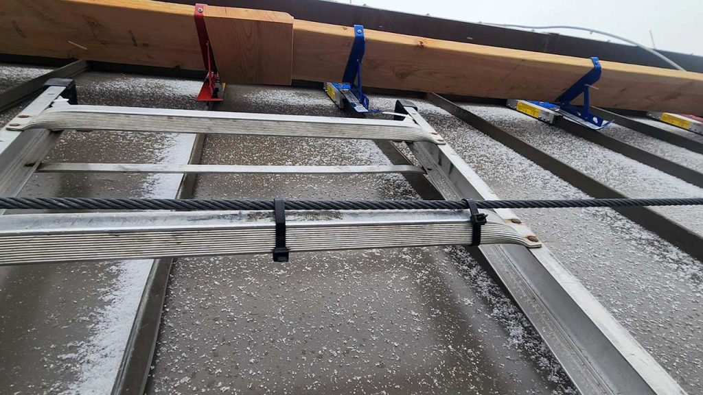 The catwalk undder the skylight and the ladder leading to it, all covered with snnow and ice.