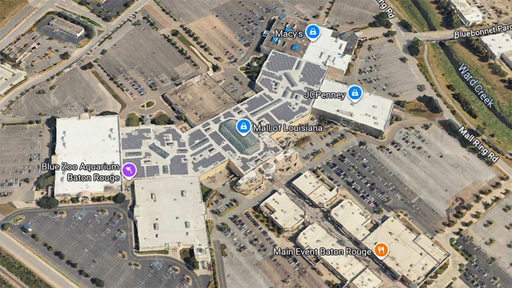 Aerial view of the Mall of Louisiana complex with labeled stores including Macy's, JCPenney, and Blue Zoo Aquarium. Busy parking lots surround the buildings.