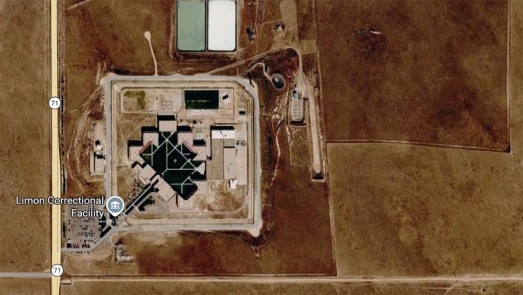Aerial view of Limon Correctional Facility in a barren landscape. Geometric building layout with roads nearby; an isolated, institutional setting.
